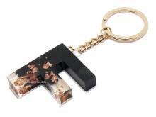 Schl&uuml;sselanh&auml;nger/Taschenanh&auml;nger Gro&szlig;buchstabe F Epoxidharz schw./transparent ros�goldf. Zierflocken Schl&uuml;sselring